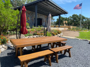 Quality Patio Furniture 8 ft. Heavy Duty Picnic Table with four 4 ft. Separate Benches with American Flag flying in the background