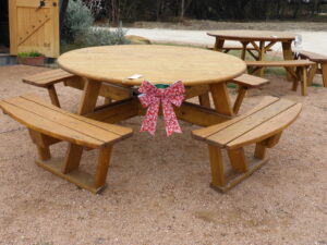 Quality Patio Furniture Round Picnic Table with Attached Benches decorated with Red & White Bow
