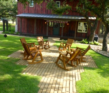 Quality Patio Furniture Rocking Chairs in a rustic setting Handcrafted by Jack Hudson (830) 367-3848 Rocking Chairs on a brick patio surrounded by grass and trees Quality Patio Furniture Handcrafted by Jack Hudson (830) 367-3848